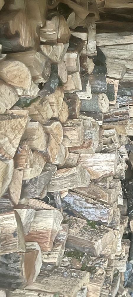 Stack of split hardwood firewood ready for delivery